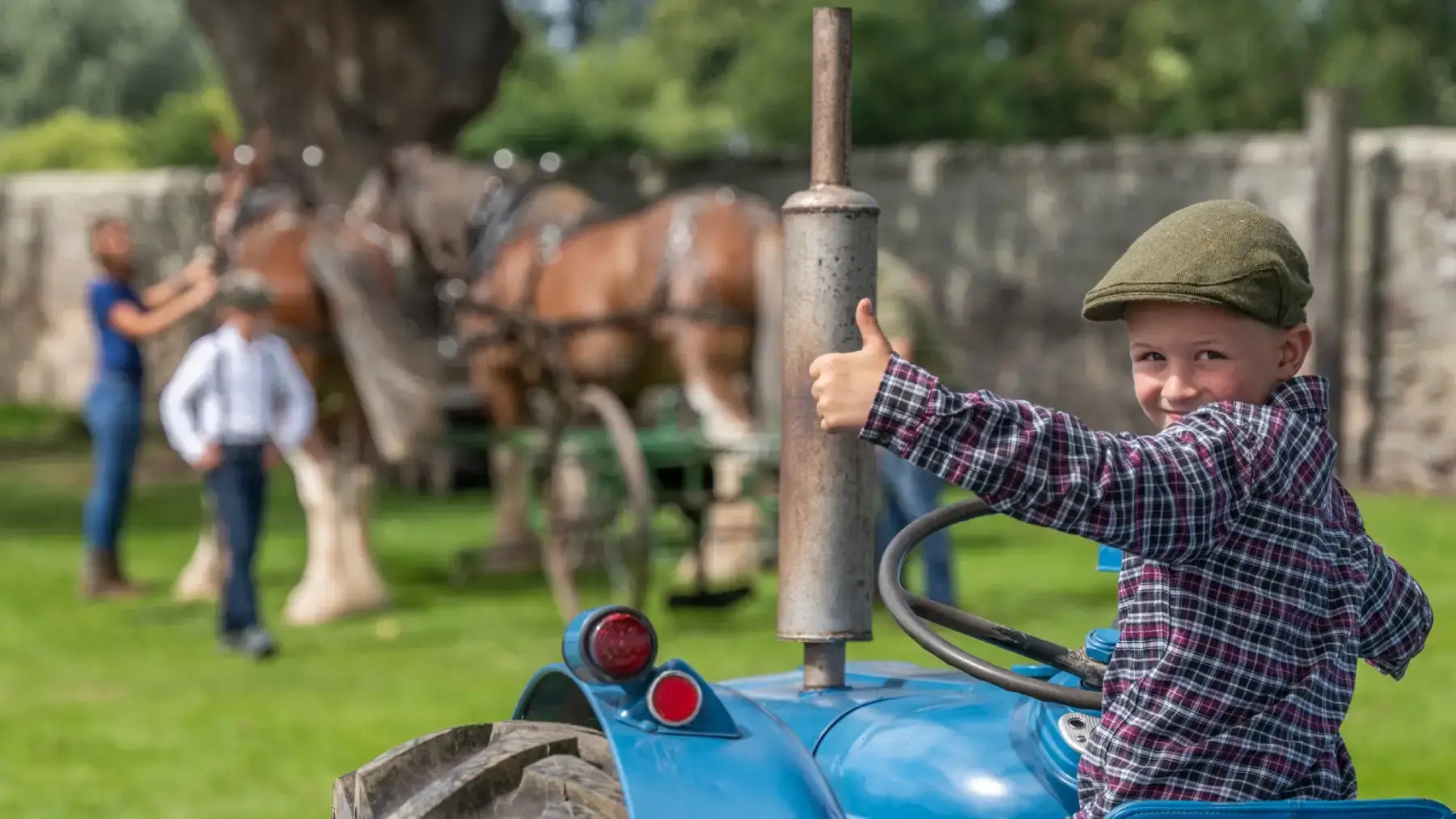 kid on tractor thumbs up